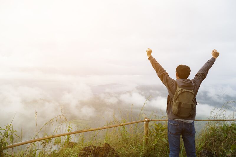 Person backpacking feeling happy